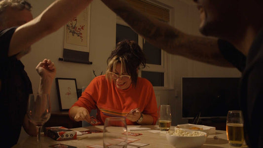 Three people play a party board game